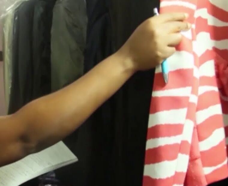 Cleaned garments on hangers being checked at Lashone Laundry